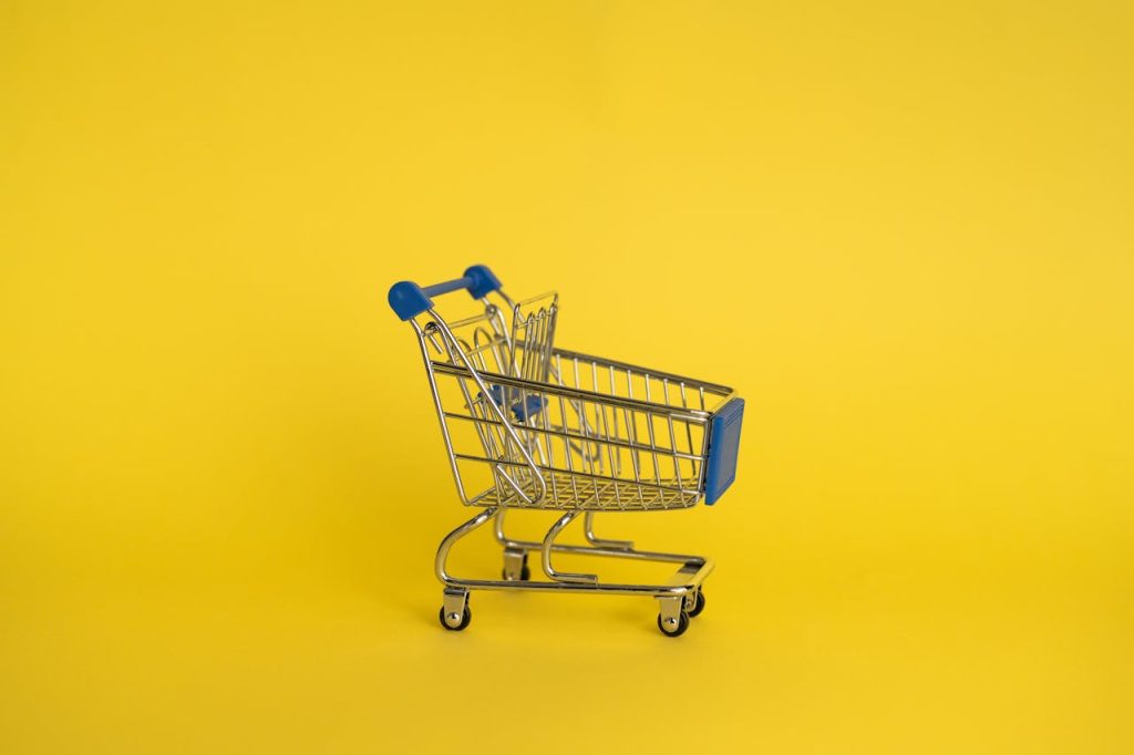 empty-shopping-cart-on-yellow-background-7195232 Isolated shining metal shopping trolley without anything located separately on yellow background